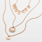 ARDEN 3-in-1 crystal necklace in rose-gold, featuring three layered chains with hammered disc charms and a crystal-bordered pendant, offering a feminine and ethnic-inspired design.