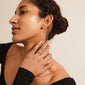 Woman showcasing the SOLIDARITY bubbles ring, silver-plated with irregular spherical details, emphasizing a cool, stacked style from Pilgrim's recycled collection.