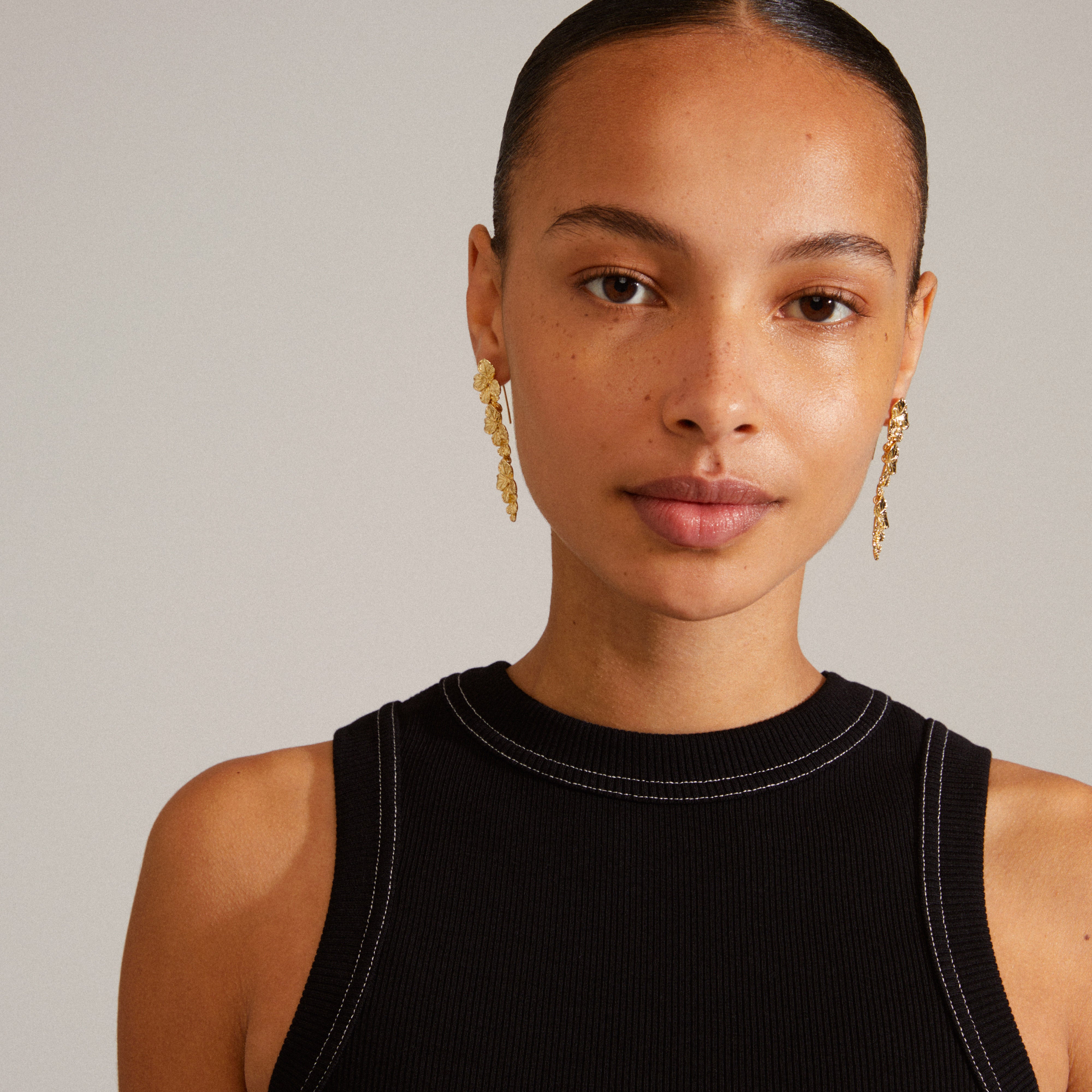 Gold-plated ECHO earrings from Pilgrim, featuring flower vine design, adding elegance and shine to any outfit, crafted from 99% recycled materials.