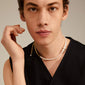 BEAT pearl necklace gold-plated, featuring an asymmetrical mix of curb chain and pearls, worn by a man in a black shirt, showcasing empowerment and style.