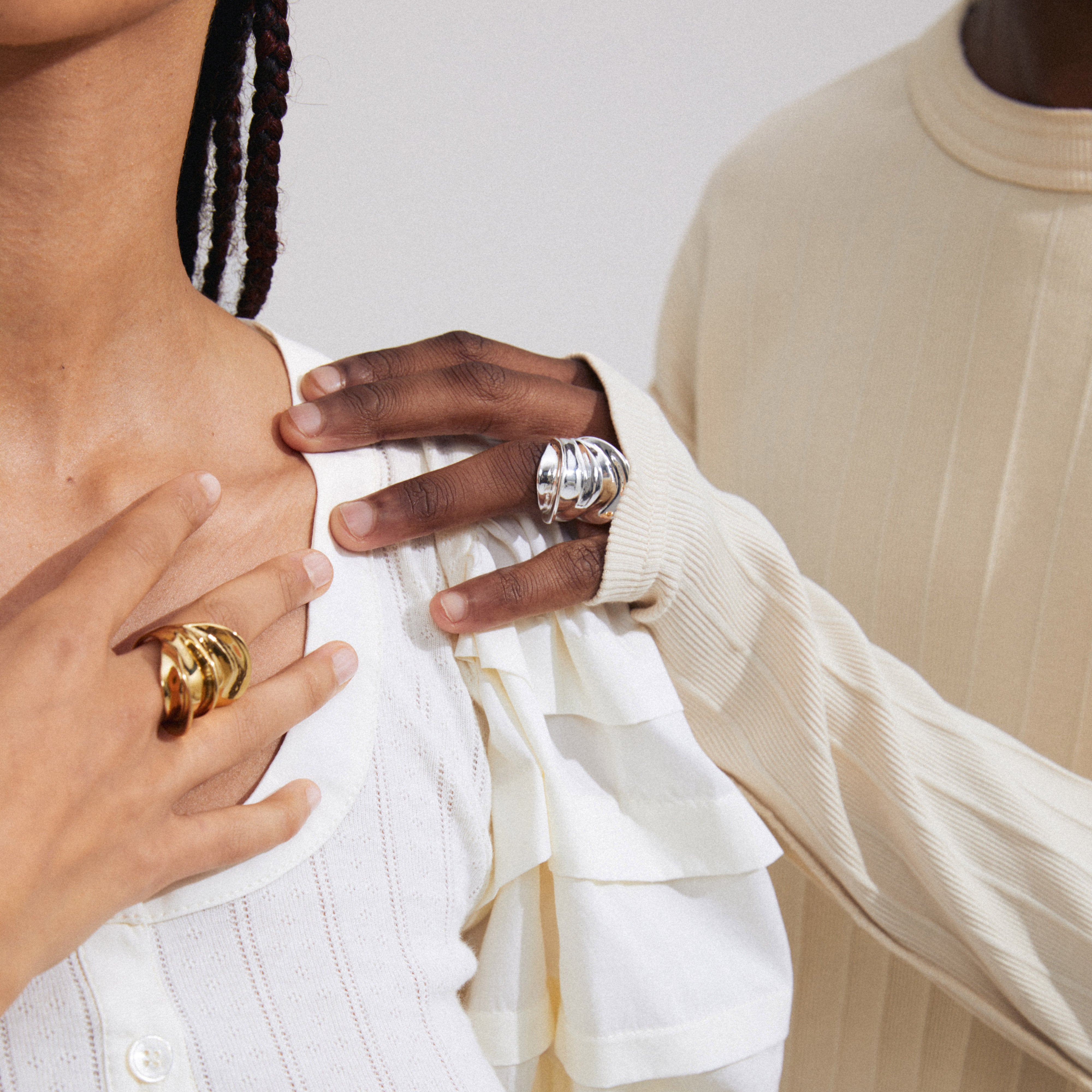 Close-up of a man and woman showcasing the STAY ring gold-plated from Pilgrim, highlighting its chunky, eye-catching design and adjustable fit.