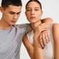Young man and woman wearing Pilgrim's gold-plated PHASE rings, showcasing modern, minimalist style with Scandinavian design emphasis on authenticity and sustainability.