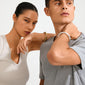 Two models showcase Pilgrim's PHASE bangle silver-plated: a sleek, chunky design on the right model's wrist, symbolizing strength and style.