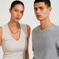 Two young adults showcasing the PHASE necklace silver-plated by Pilgrim, highlighting its sleek, genderless design with urban edge and adjustable length.