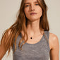 Woman wearing CHAKRA Black Agate necklace; a silver-plated chain with a unique black agate pendant, symbolizing stability and grounding.