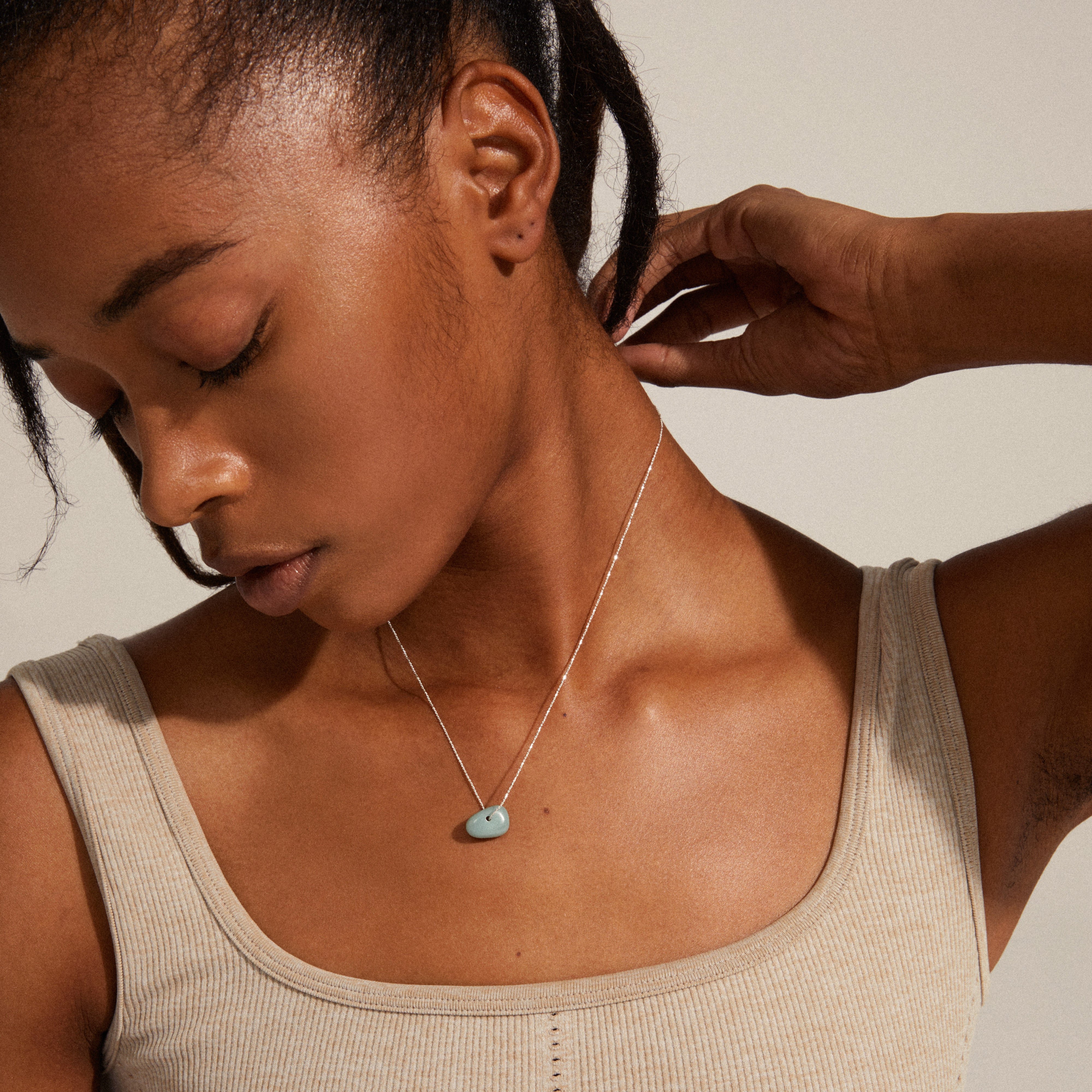 CHAKRA Amazonite necklace silver-plated displayed on a woman's neck, highlighting its green pendant and elegant chain, reflecting Pilgrim's Danish handmade jewellery style.