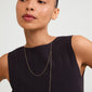 BREEZE necklace 2-in-1 set gold-plated, featuring a turtle charm with crystals and a freshwater pearl, worn by a woman in a black dress.