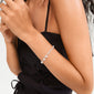 BREEZE bracelet silver-plated on woman's wrist, featuring layered chains with pearls and crystals, capturing Pilgrim's trendy, sustainable style.