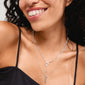 Woman smiling, showcasing the BREEZE necklace 2-in-1 set, featuring silver-plated chains with a turtle pendant and freshwater pearl, by Pilgrim.