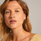 KIKU half hoop earrings gold-plated, featuring Asian-inspired patterns, elegantly hanging from slender hooks, offering a feminine and bohemian touch.