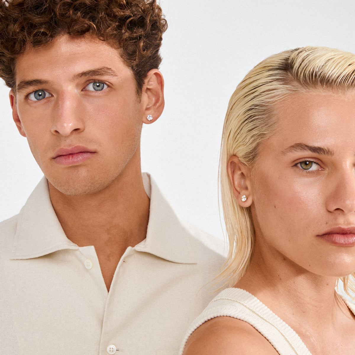 Two young models wear ORIGINAL crystal earstuds gold-plated, featuring clear Preciosa stones, showcasing Pilgrim's blend of timeless elegance and modern style.