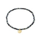 INDIE bracelet in dark grey with faceted glass beads and a subtle gold-plated Pilgrim logo charm, strung on durable Lycra elastic for versatile wear.