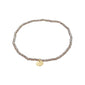INDIE bracelet grey, gold-plated, featuring small faceted glass beads and a discreet gold disc, strung on durable elastic, perfect for a personalized, trendy look.