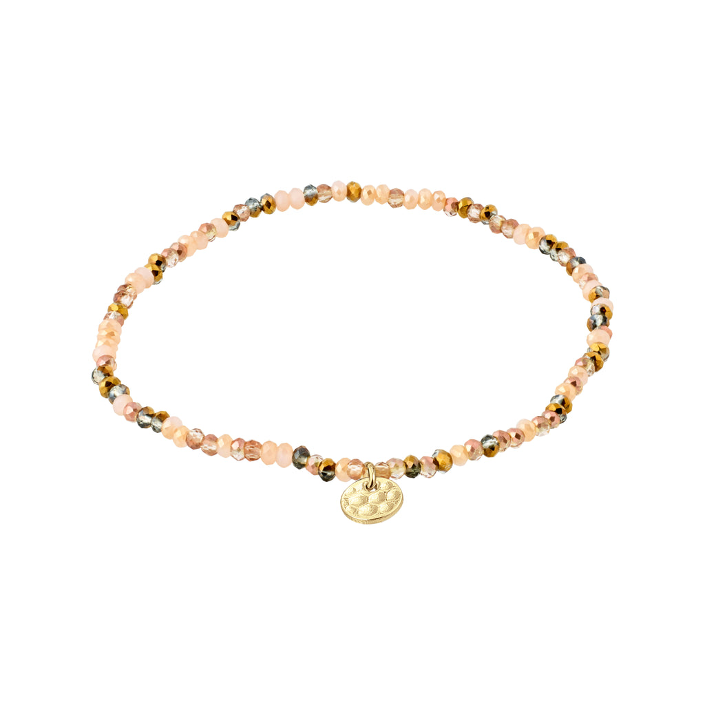 INDIE bracelet featuring faceted beige glass beads and a gold-plated Pilgrim logo charm, strung on durable elastic for a comfortable fit.