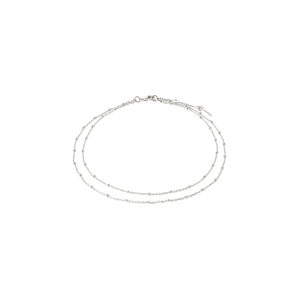 ELKA ankle chain 2-in-1 silver-plated, featuring two delicate chains with small round pendants, offering a chic, layered look.