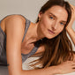 Woman modeling PIA organic shape crystal hoop earrings, gold-plated, showcasing their natural, irregular design and sparkling Preciosa crystals, embodying Pilgrim's Scandinavian-inspired elegance.