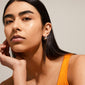 PIA organic shape crystal hoop earrings, silver-plated, showcased by a model. Features shiny surface and Preciosa crystals, embodying Pilgrim's handcrafted, minimalistic style.