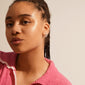Woman with braided hair wearing SOLIDARITY medium bubbles hoops, silver-plated earrings, featuring playful asymmetric bubble design for a modern, stylish look.