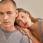 OCTAVIA clover earrings gold-plated; man and woman pose, highlighting the earrings' elegant, trendy design. Ideal for mixing with other earrings.
