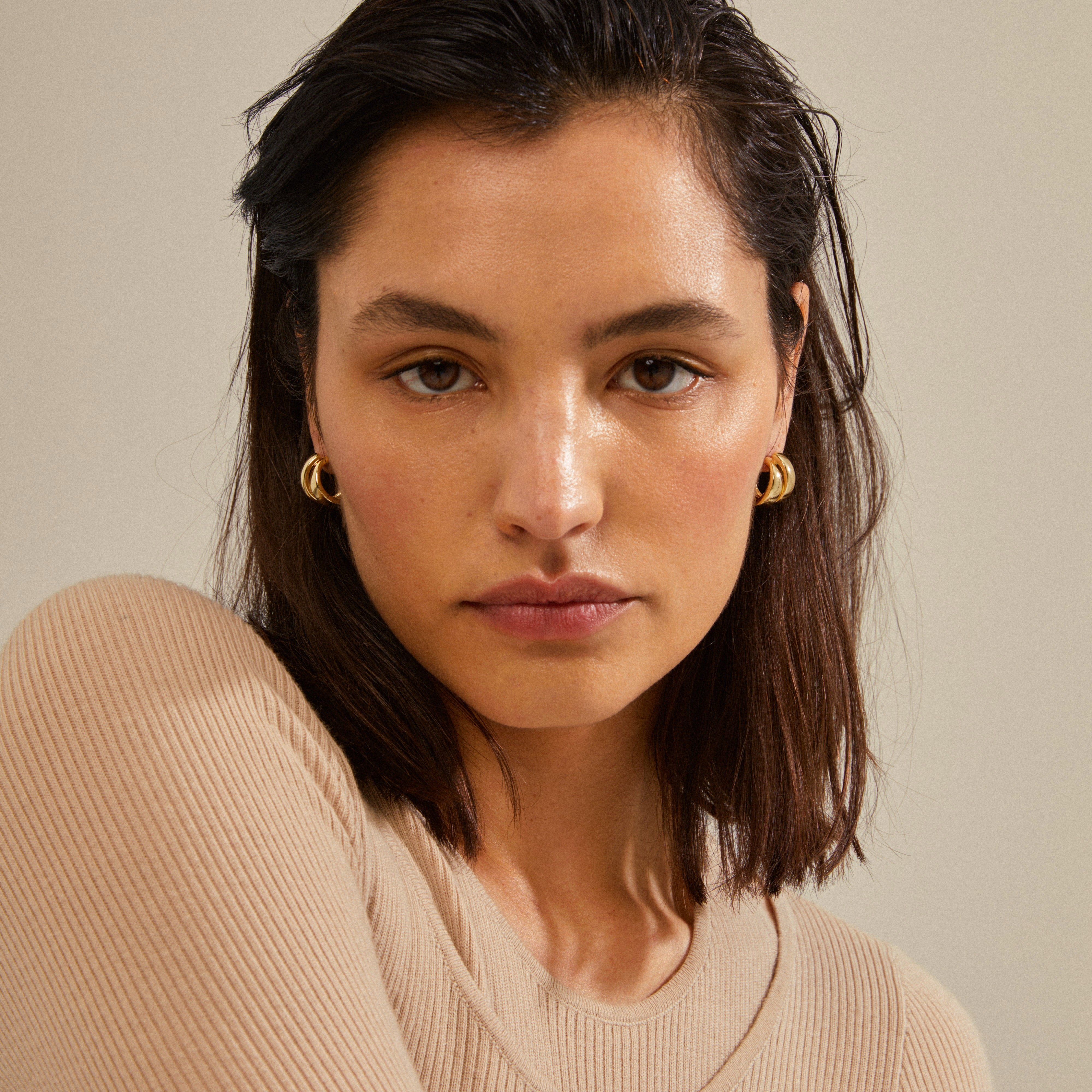 Gold-plated ORIT earrings with a chunky, curved silhouette, offering a trendy accessory ideal for accentuating a stylish, modern outfit.