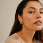 Gold-plated ORIT earrings with a chunky, curved silhouette, perfect as a trendy accessory for a stylish, modern look. Made from 98% recycled materials.