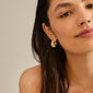 Close-up of a woman wearing NAOMI crystal hoops gold-plated, showcasing the chunky, sparkling design with Preciosa crystals from Pilgrim.