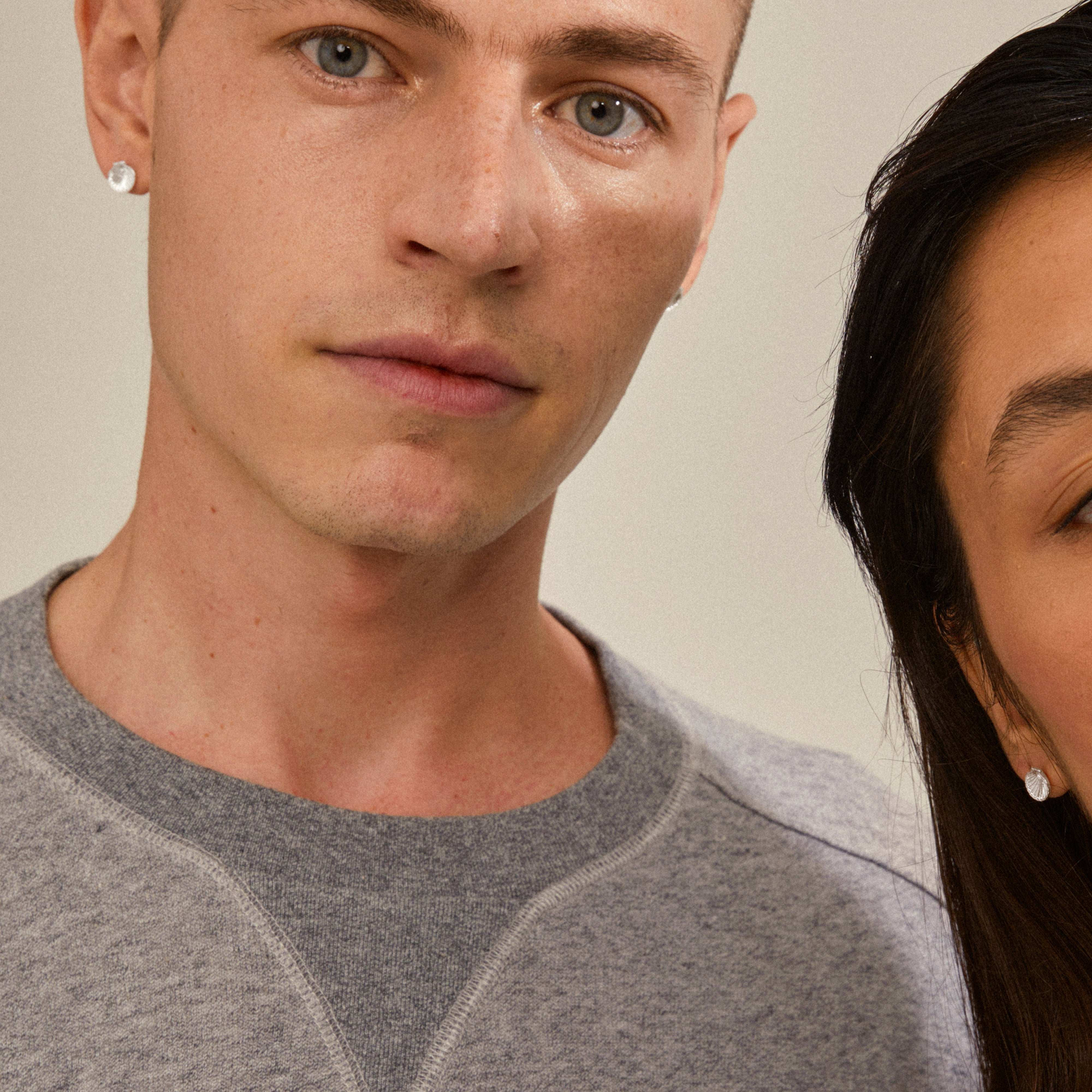 OPAL seashell earrings silver-plated on young man, showcasing their delicate design with seashell and bead, ideal for a trendy, curated ear look.