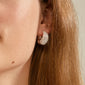 Close-up of an ear wearing NAOMI crystal hoops silver-plated, showcasing chunky half-hoop design with sparkling Preciosa crystals, perfect for elegant and eco-friendly style.