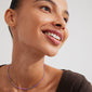 Woman smiling, wearing Pilgrim's ALISON necklace featuring purple and grey glass beads, providing a boho-inspired, layered look. Perfect for a festival-ready style.