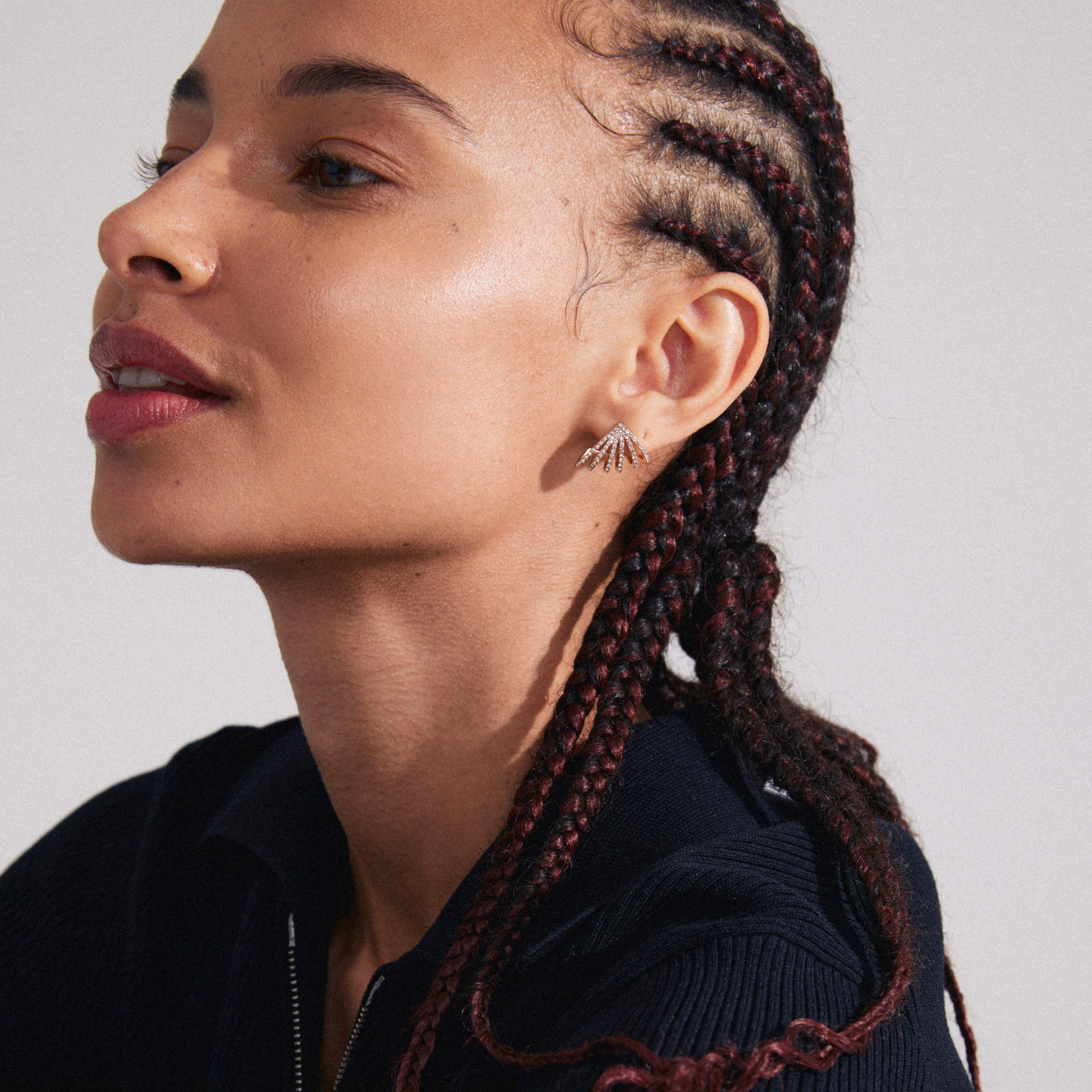 Close-up of a woman wearing gold-plated PRISCILLA earrings with shimmering Preciosa crystals, showcasing a bold, statement design perfect for accentuating a curated ear look.