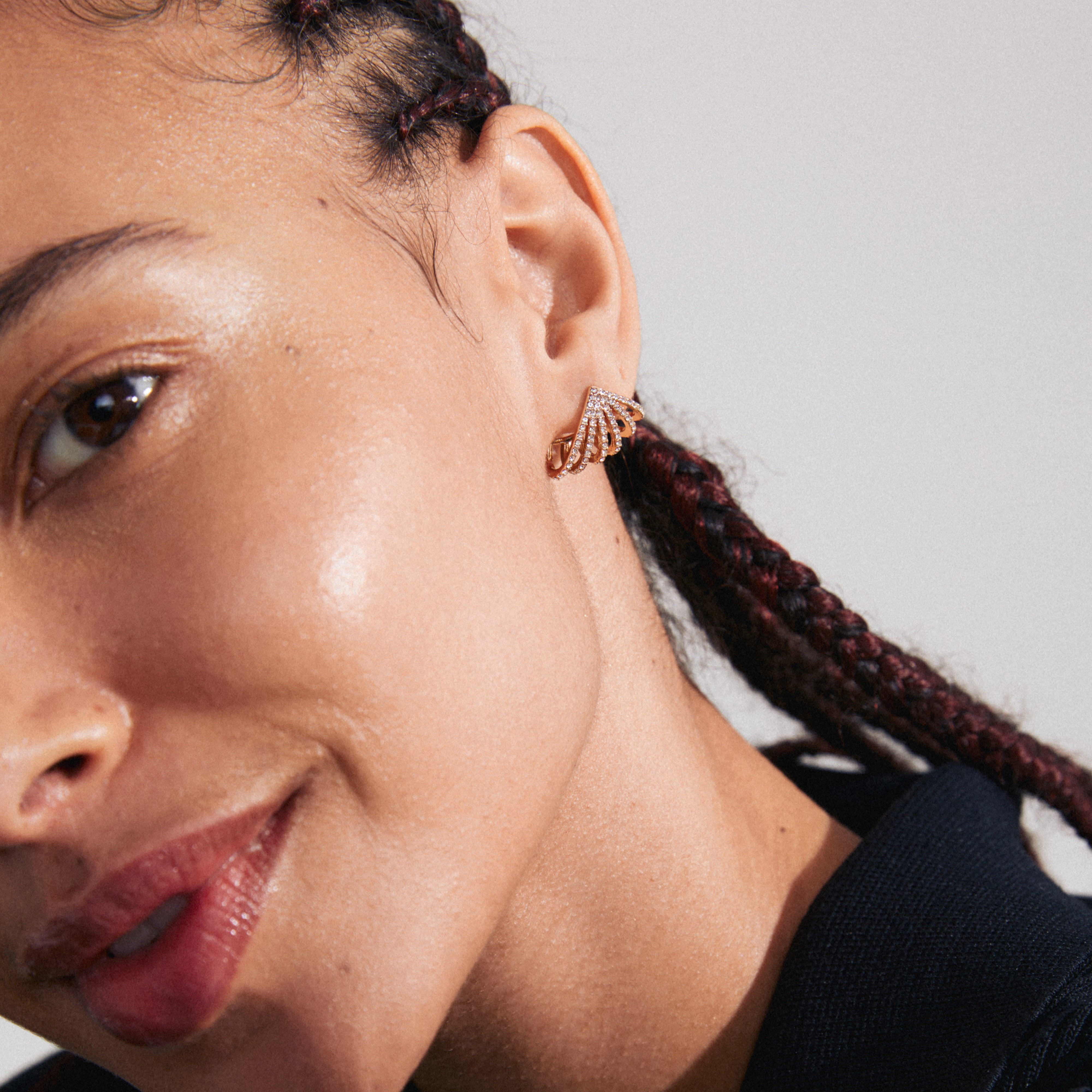 Close-up of a woman wearing PRISCILLA earrings gold-plated, featuring shimmering Preciosa crystals in a sunray-inspired design, capturing attention with its unique style.