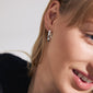 Close-up of a woman's face wearing ASHER silver-plated hoops, showcasing their chunky, oval design and click clasp from Pilgrim.