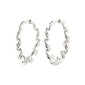 LARISA earrings silver-plated with twisted design, showcasing boho-inspired elegance and a click clasp for easy wear, crafted from 99% recycled materials.