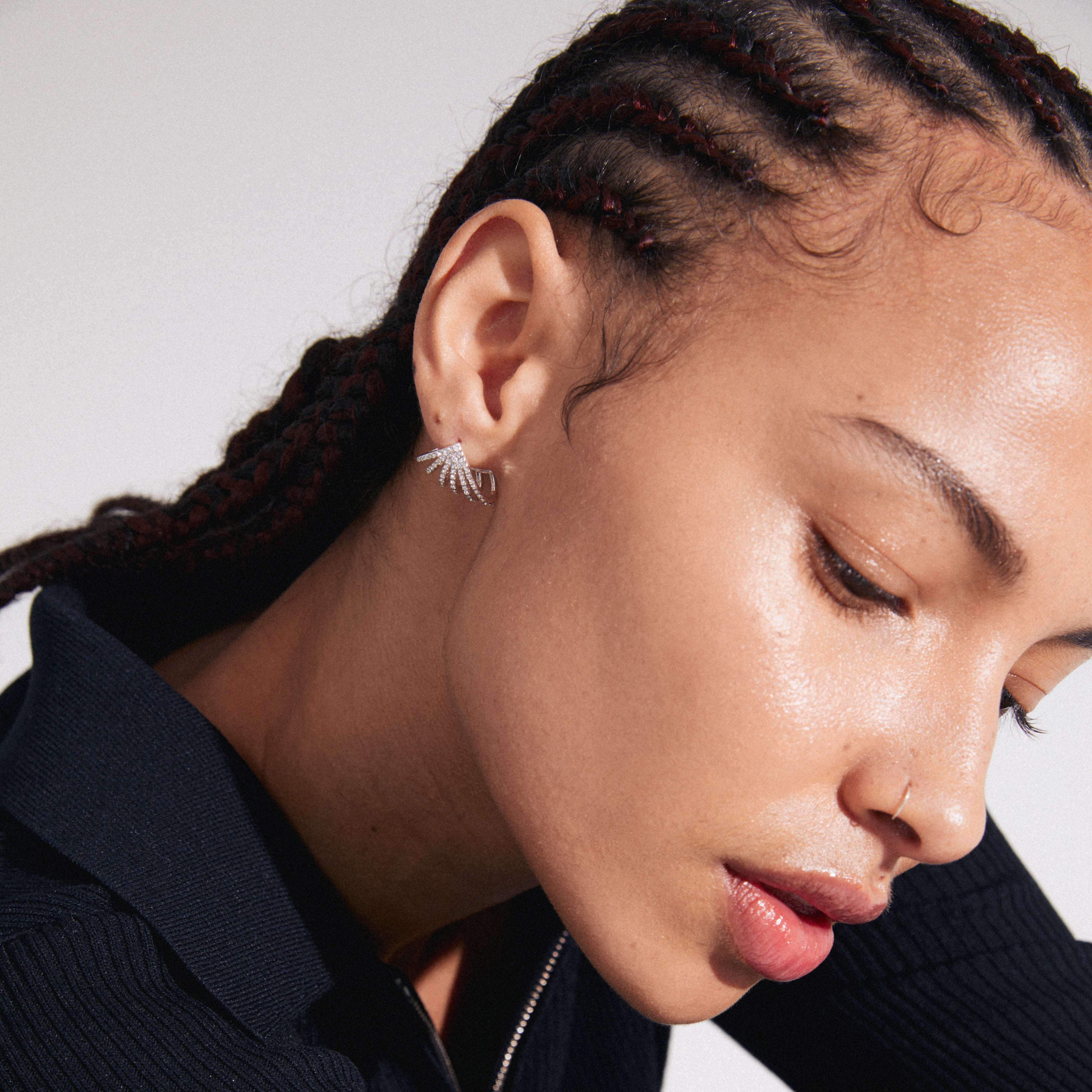 Woman wearing PRISCILLA earrings, silver-plated with shimmering Preciosa crystals, showcasing a bold, stylish look for a curated ear.