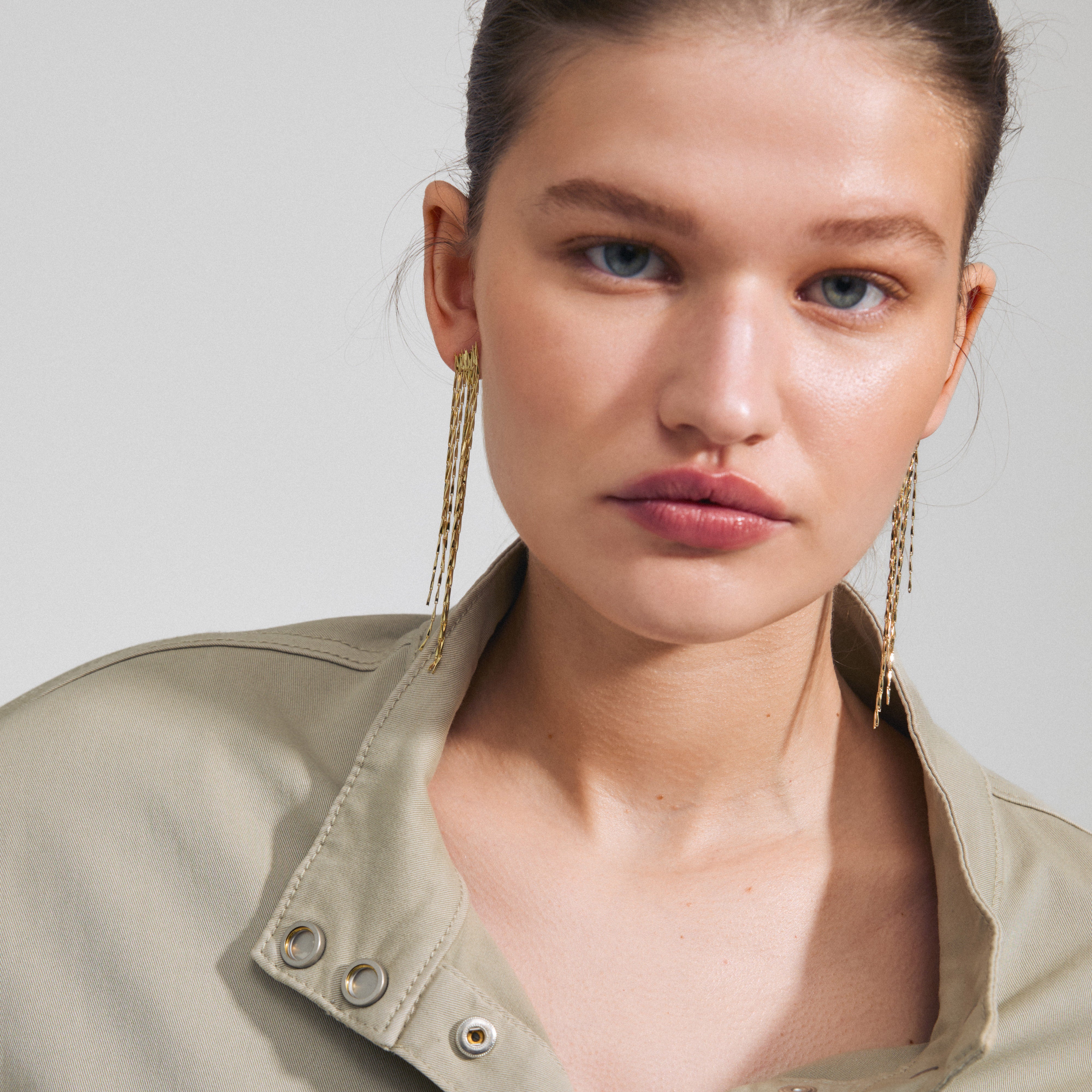 ZENOBIA gold-plated earrings featuring layered chains with twisted melon seed links, creating a sparkling waterfall effect. Perfect for parties and made from 97% recycled materials.
