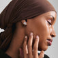 Woman wearing AIAS crystal earrings, silver-plated, highlighting their organic design with sparkling Preciosa crystals, embodying Pilgrim's blend of timeless and trendy style.