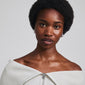Woman wearing LINCOLN silver-plated earrings by Pilgrim, showcasing chunky, rustic hoops with shiny finish and easy click clasp.