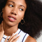 DYLAN earrings gold-plated; close-up of a woman wearing oval hoops with organic, irregular shapes, highlighting their glossy finish and trendy design.