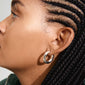 Silver-plated MARLO earrings featuring a chunky hoop design, worn by a woman with braided hair and hoop earrings, showcasing elegance and trendy charm.