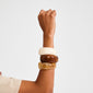 AASE maxi bangle beige: A close-up of a wrist adorned with three chunky bangles, highlighting Pilgrim's recycled ivory bangle for a chic, Scandi-inspired summer look.