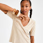 Young woman wearing the Pilgrim AASE maxi bangle beige, featuring chunky, recycled acrylic in ivory, alongside amber and tortoiseshell tones, showcasing a stylish, earthy vibe.