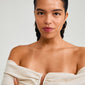 Close-up of a woman wearing gold-plated ARTEMIS earrings, showcasing their classic, Scandinavian-inspired design from Pilgrim.