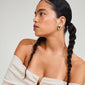 Woman wears ANNEMETTE gold-plated earrings, chunky heart design by Pilgrim, showcasing edgy, romantic style. Perfect for outfits with a touch of glamour.