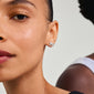Silver-plated ANDRÉ starfish stud earrings on a woman's ear, embodying beach-inspired summer vibes, crafted from recycled materials by Pilgrim.