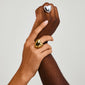Hands gently holding, showcasing the silver-plated ANNEMETTE ring by Pilgrim, featuring a prominent heart design, ideal for adding a romantic, trendy flair.