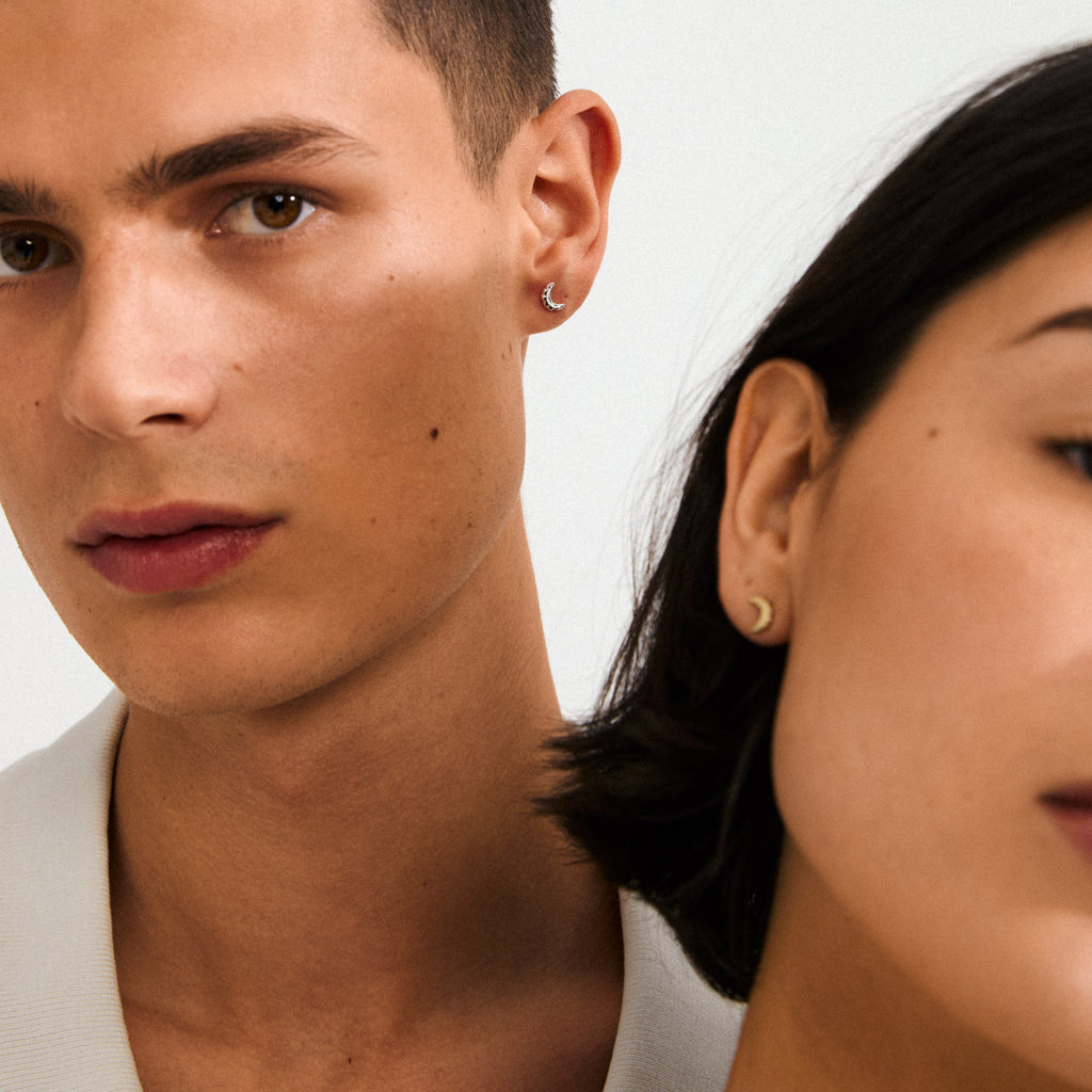Gold-plated moon earrings by Pilgrim, showcasing rustic crescent design for a fairytale vibe, crafted from recycled materials, ideal for casual or elegant outfits.