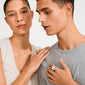 Two young adults wearing minimal attire, highlighting the JAMESON ring. The woman sports a gold-plated, sculptural band ring with a bubble dome design.