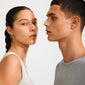 Two young adults showcasing Pilgrim's FREE gold-plated stud earrings, highlighting their organic, minimalist design inspired by hagstones for everyday style.
