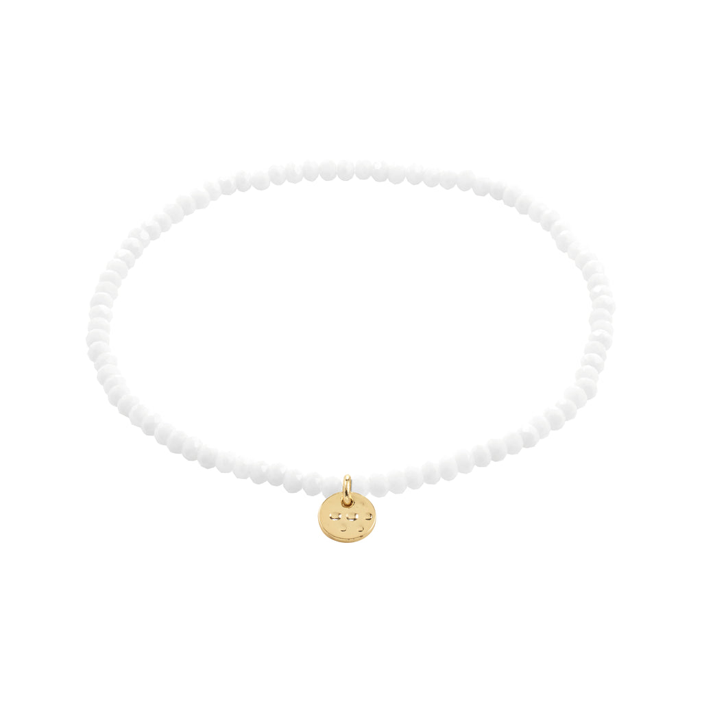 INDIE bracelet white, gold-plated: A simple choker-style piece featuring faceted white beads and a small gold-tone disc charm on elastic for versatile wear.