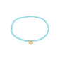 INDIE bracelet skyblue features faceted blue beads and a gold-plated disc, elegantly designed for stacking. Elastic fit, perfect for versatile styling.